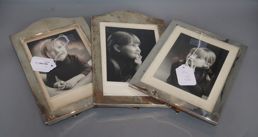 A pair of silver photograph frames, London, 1928 (one set of marks rubbed), 26.8cm and one other frame(a.f.).